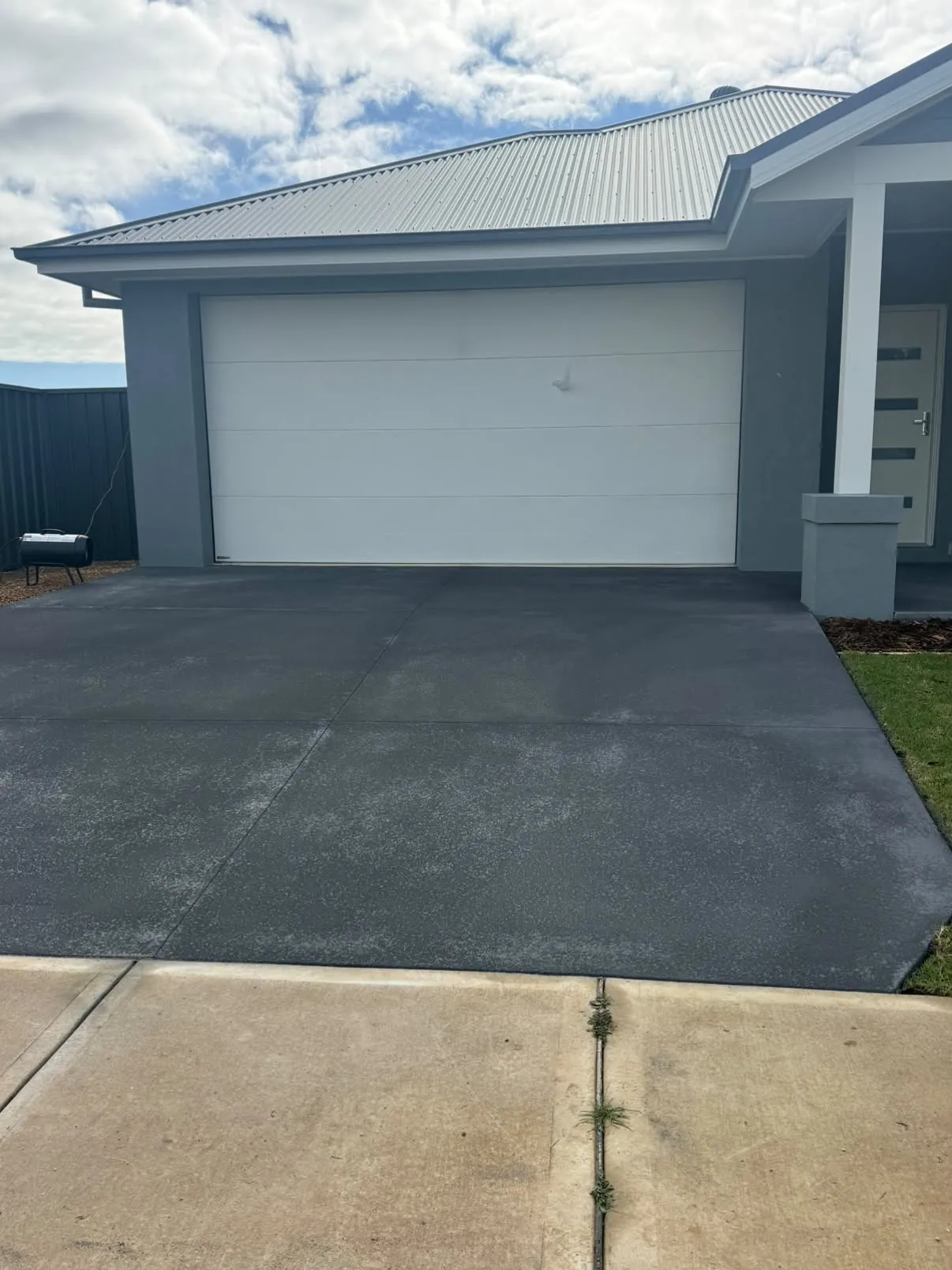 Driveway resurfaced with charcoal spray pave